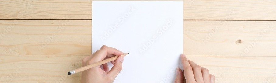 hands with a pencil over a blank sheet of paper.